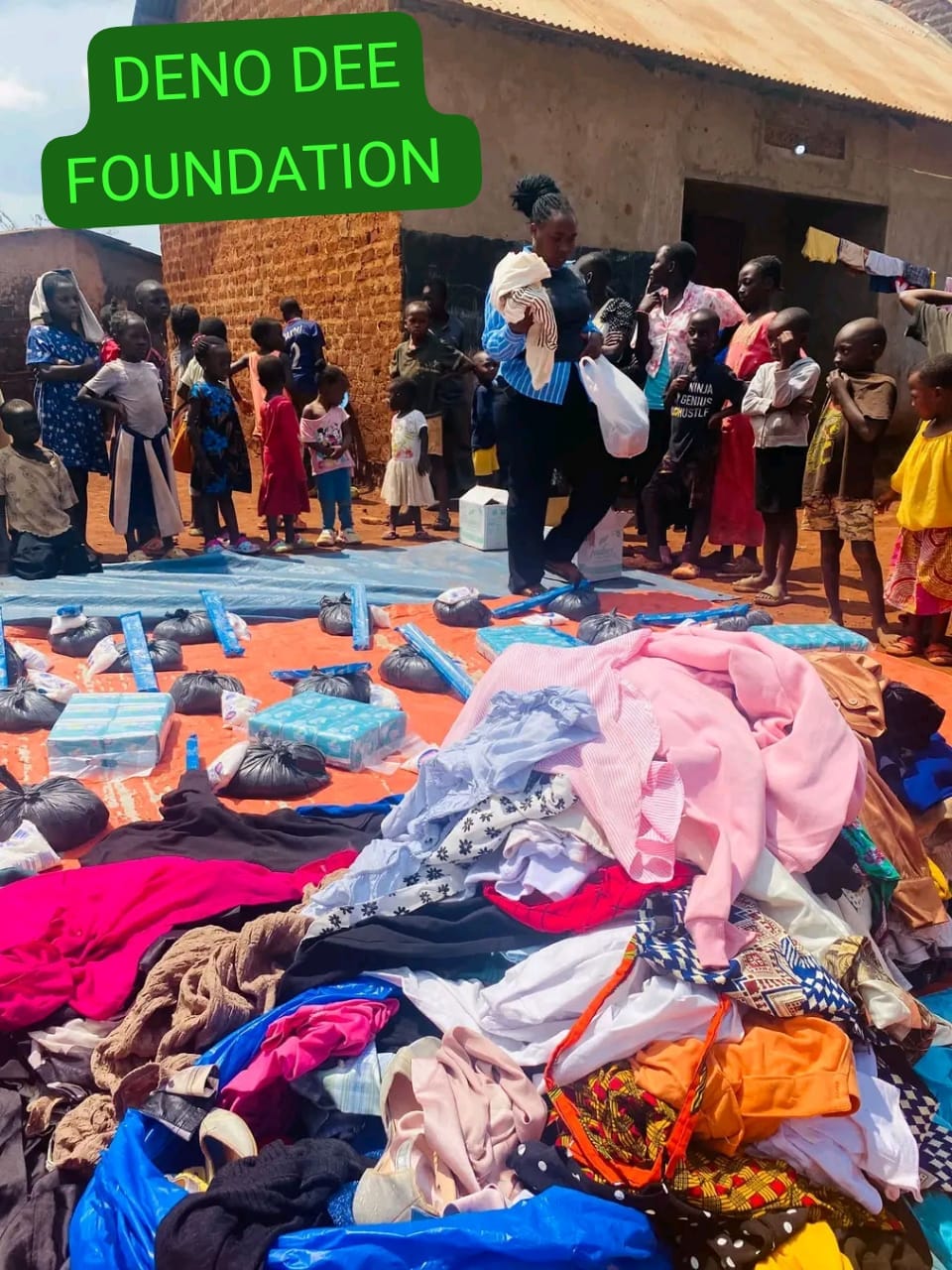 Children lining up as clothes, soap and essentials are laid out for distribution